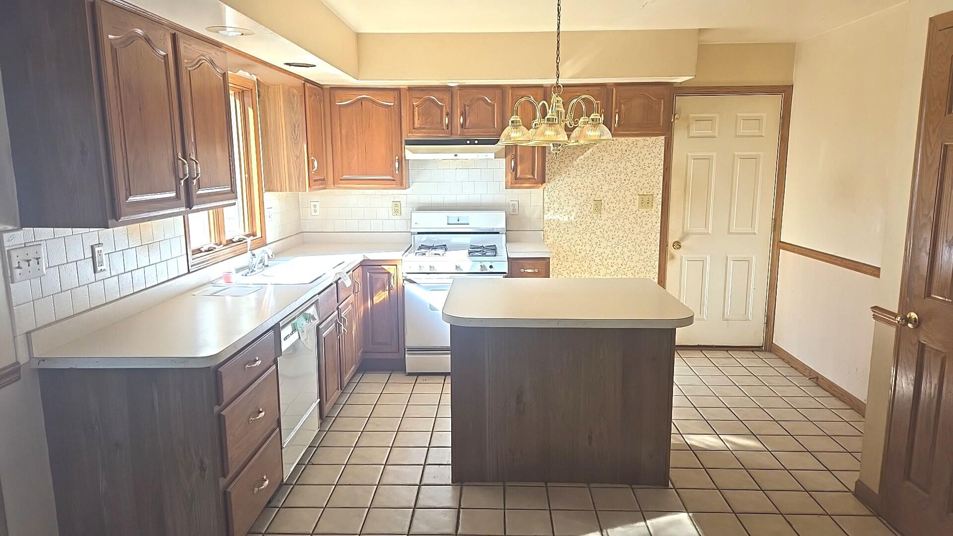 1951 West Ash Street Griffith, IN 46319 - Photo 12 of 23 a view of a kitchen with stainless steel appliances granite countertop a sink and a refrigerator