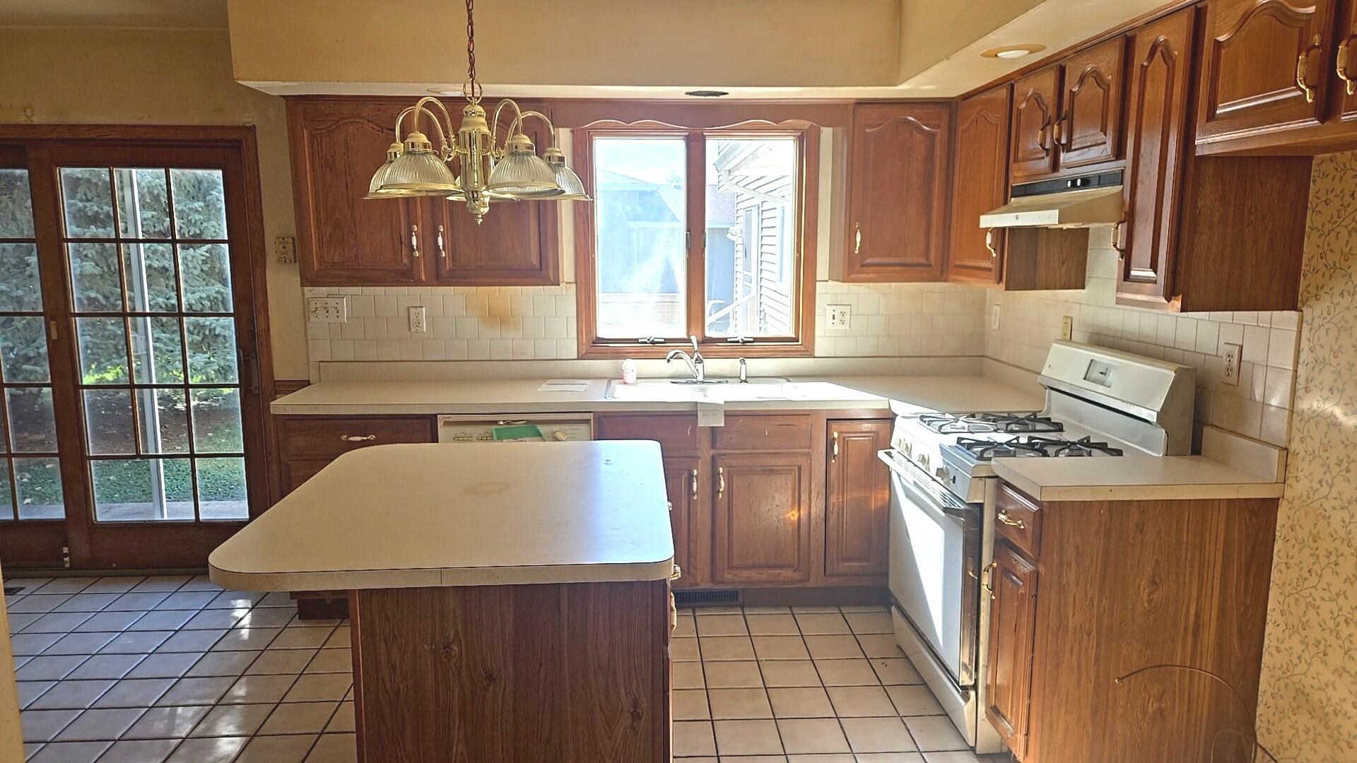 1951 West Ash Street Griffith, IN 46319 - Photo 13 of 23 a kitchen with a stove a sink dishwasher and a refrigerator