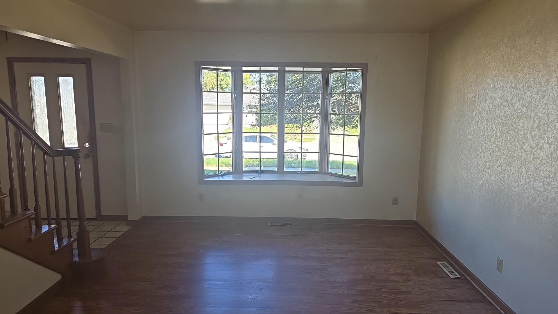 1951 West Ash Street Griffith, IN 46319 - Photo 7 of 23 an empty room with wooden floor and windows