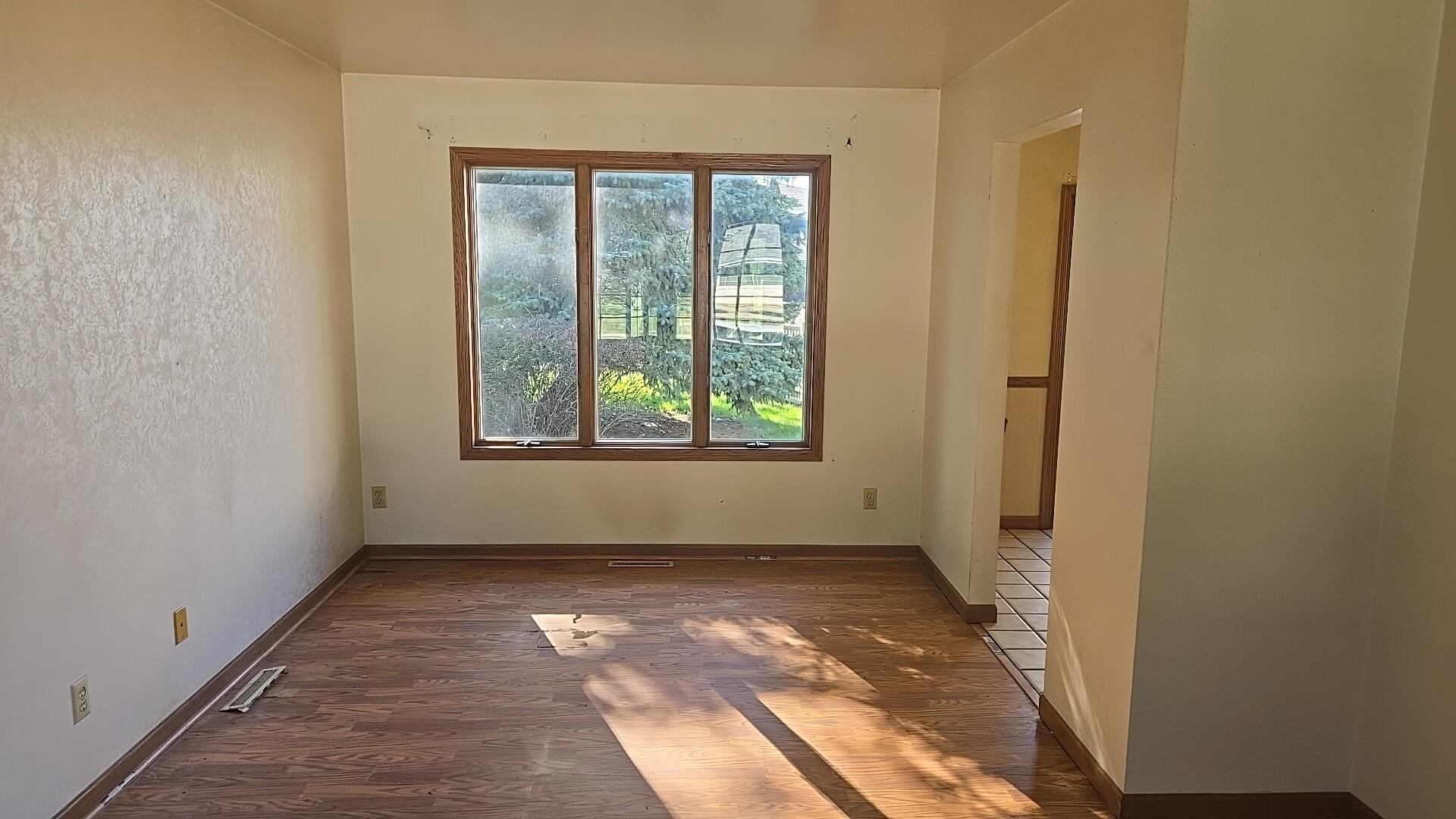 1951 West Ash Street Griffith, IN 46319 - Photo 8 of 23 an empty room with wooden floor and windows