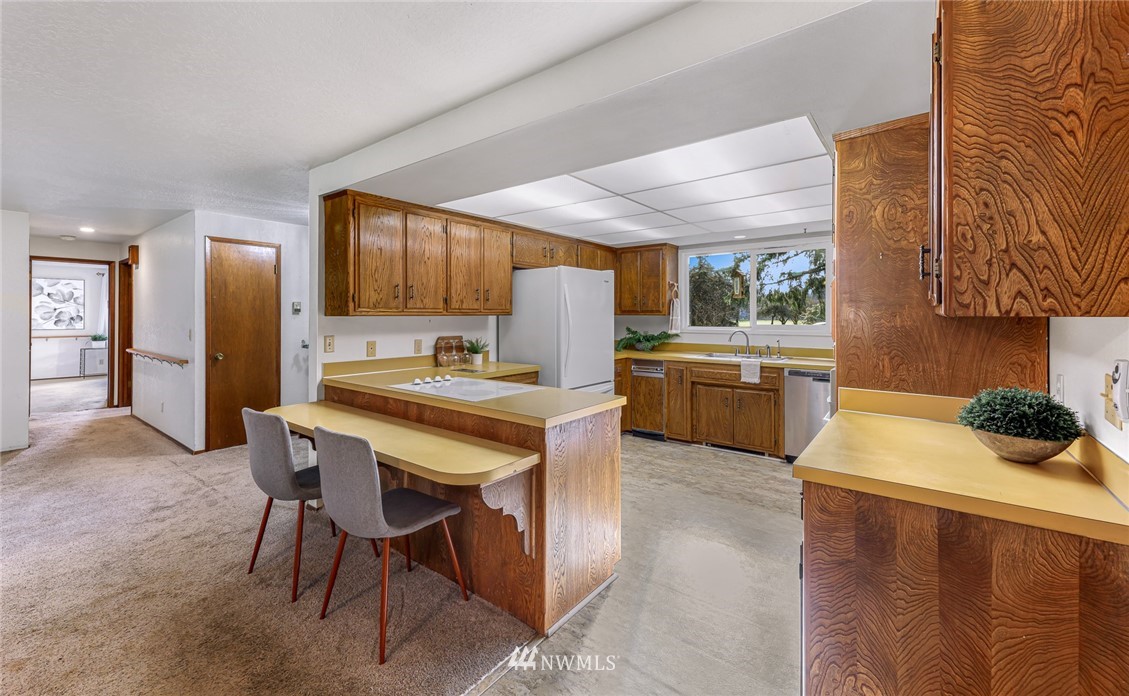 1844 Matz Road Ferndale, WA 98248 - Photo 8 of 39 a kitchen with a table chairs refrigerator and microwave