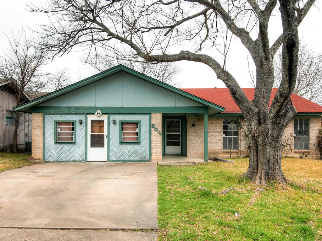 802 Buckingham Place Austin, TX 78745 - Photo 1 of 1 a front view of a house with a yard