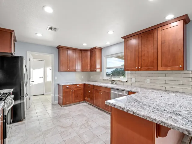 a kitchen with a sink cabinets and window