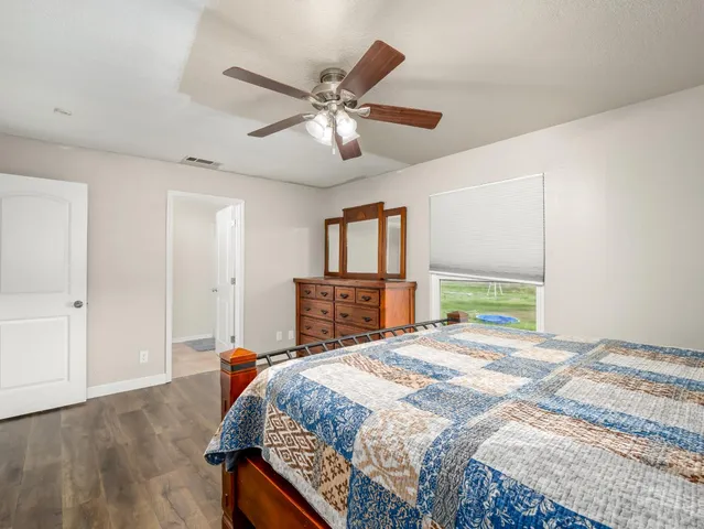 a bedroom with a large bed and a window