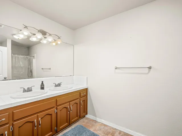 a bathroom with a sink vanity and mirror