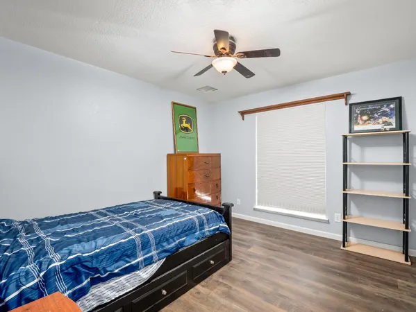 a bedroom with a bed and a ceiling fan