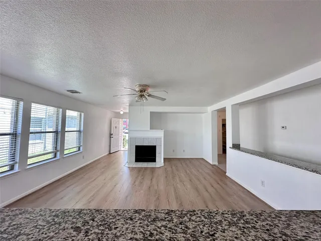 wooden floor in an empty room with a fireplace