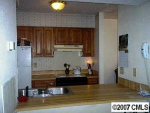 11111 Harrowfield Road, Unit 8224 Charlotte, NC 28226 - Photo 7 of 8 a kitchen with a sink and cabinets