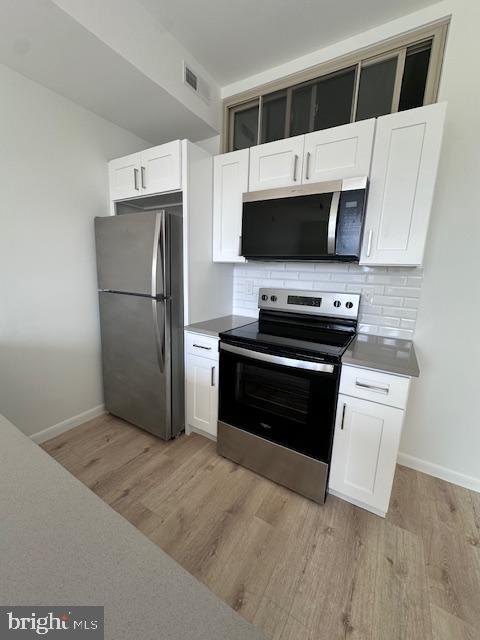 7248 Rising Sun Avenue Philadelphia, PA 19111 - Photo 4 of 25 a kitchen with stainless steel appliances a stove a microwave and a refrigerator