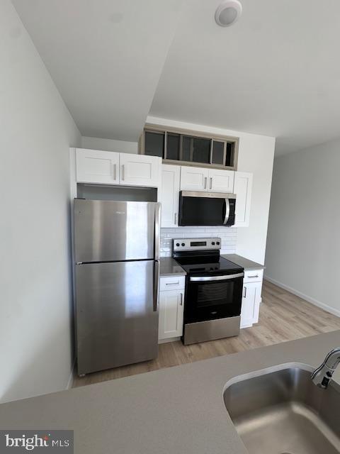 7248 Rising Sun Avenue Philadelphia, PA 19111 - Photo 5 of 25 a kitchen with stainless steel appliances a stove a microwave and a refrigerator
