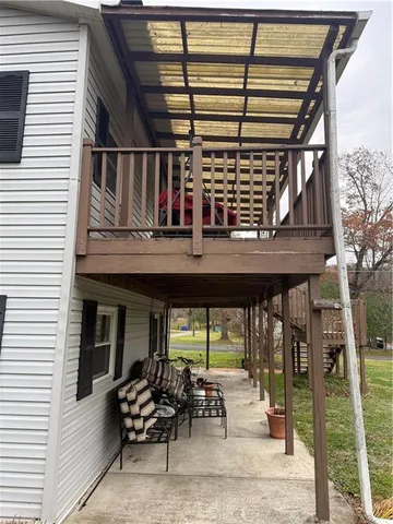 a view of a house with a yard and sitting area