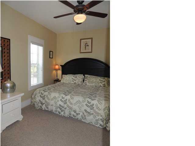 134 Somerset Bridge Road Santa Rosa Beach, FL 32459 - Photo 15 of 36 a bedroom with a bed and a chandelier