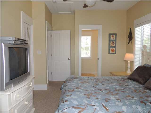 134 Somerset Bridge Road Santa Rosa Beach, FL 32459 - Photo 17 of 36 a bedroom with a bed and a flat screen tv