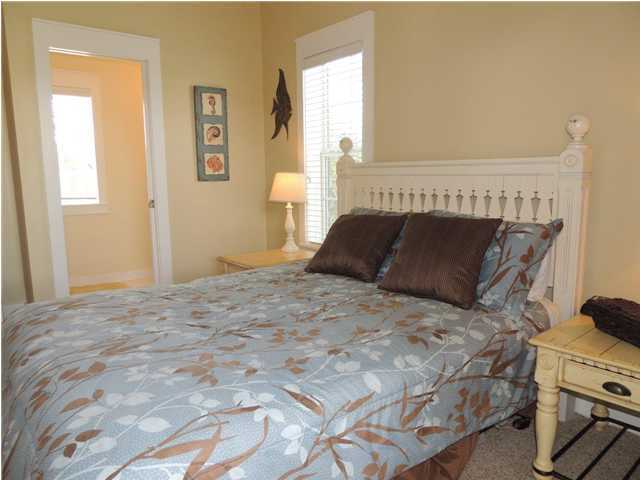 134 Somerset Bridge Road Santa Rosa Beach, FL 32459 - Photo 18 of 36 a bedroom with a bed and wooden floor