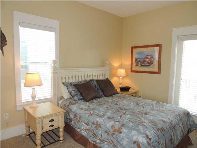 134 Somerset Bridge Road Santa Rosa Beach, FL 32459 - Photo 20 of 36 a bedroom with a bed and wooden floor