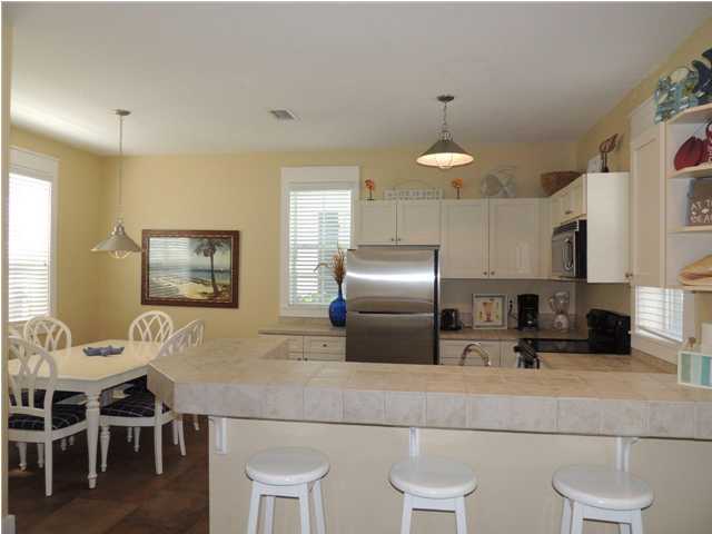 134 Somerset Bridge Road Santa Rosa Beach, FL 32459 - Photo 22 of 36 a kitchen with cabinets and chairs