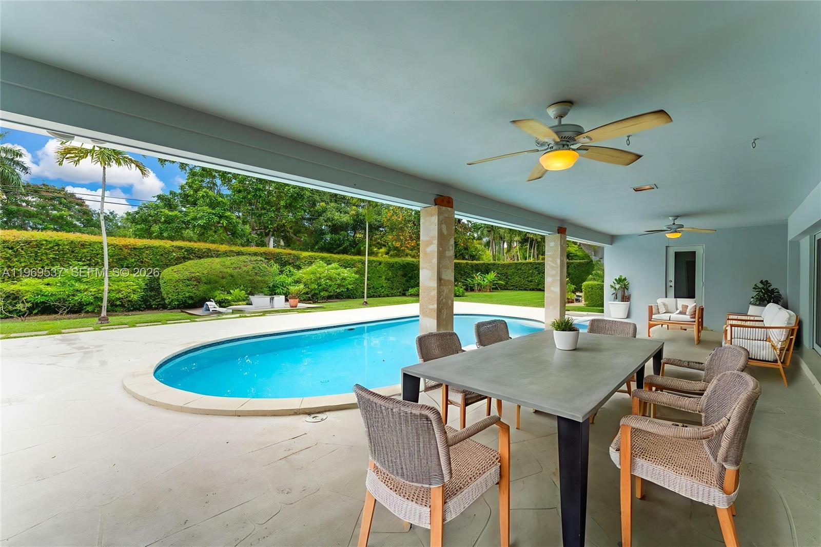 7451 Southwest 133rd Street Pinecrest, FL 33156 - Photo 13 of 36 Covered patio overlooking the pool