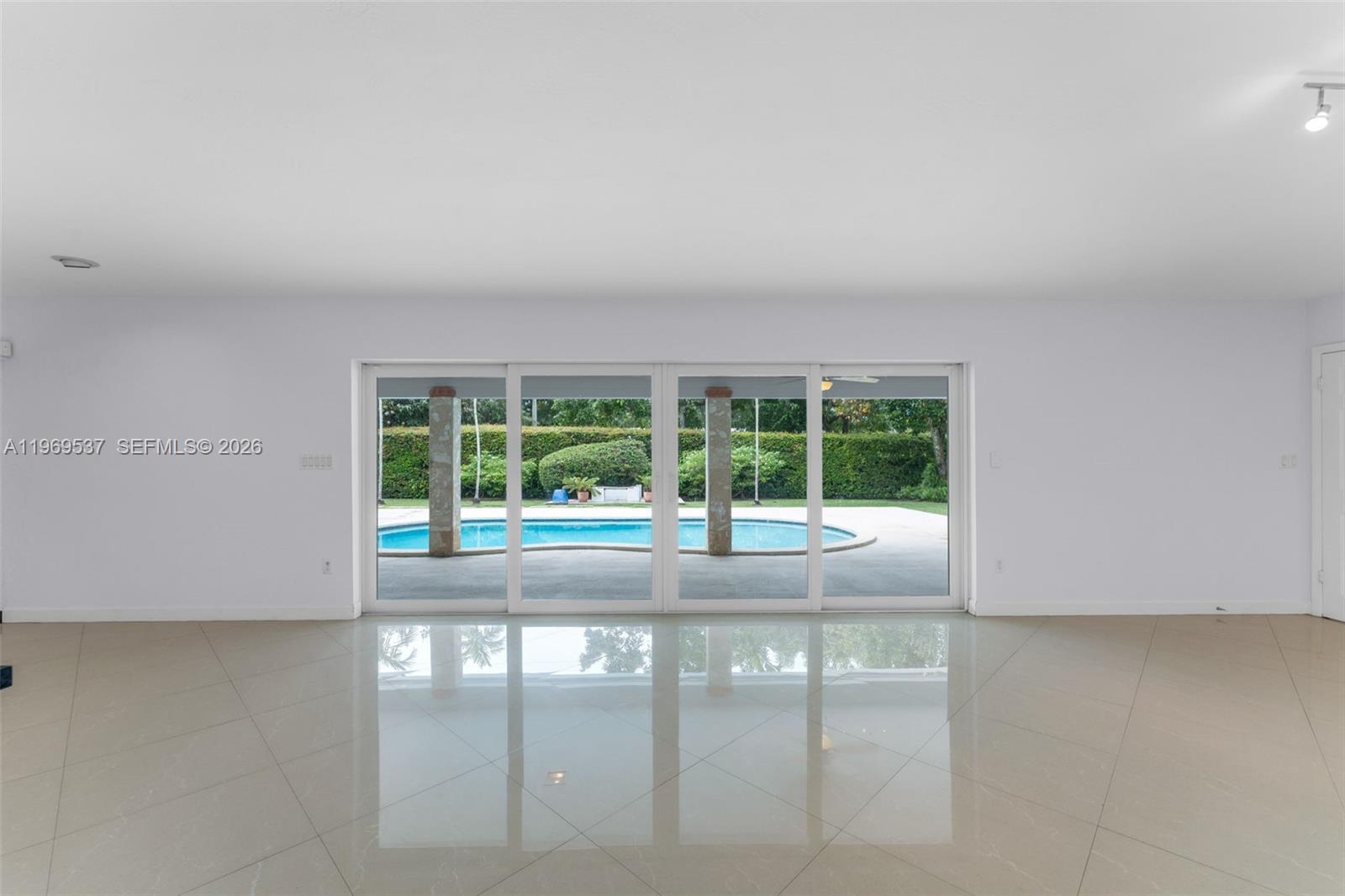 7451 Southwest 133rd Street Pinecrest, FL 33156 - Photo 14 of 36 Beautiful view on the pool area from your living and dining area