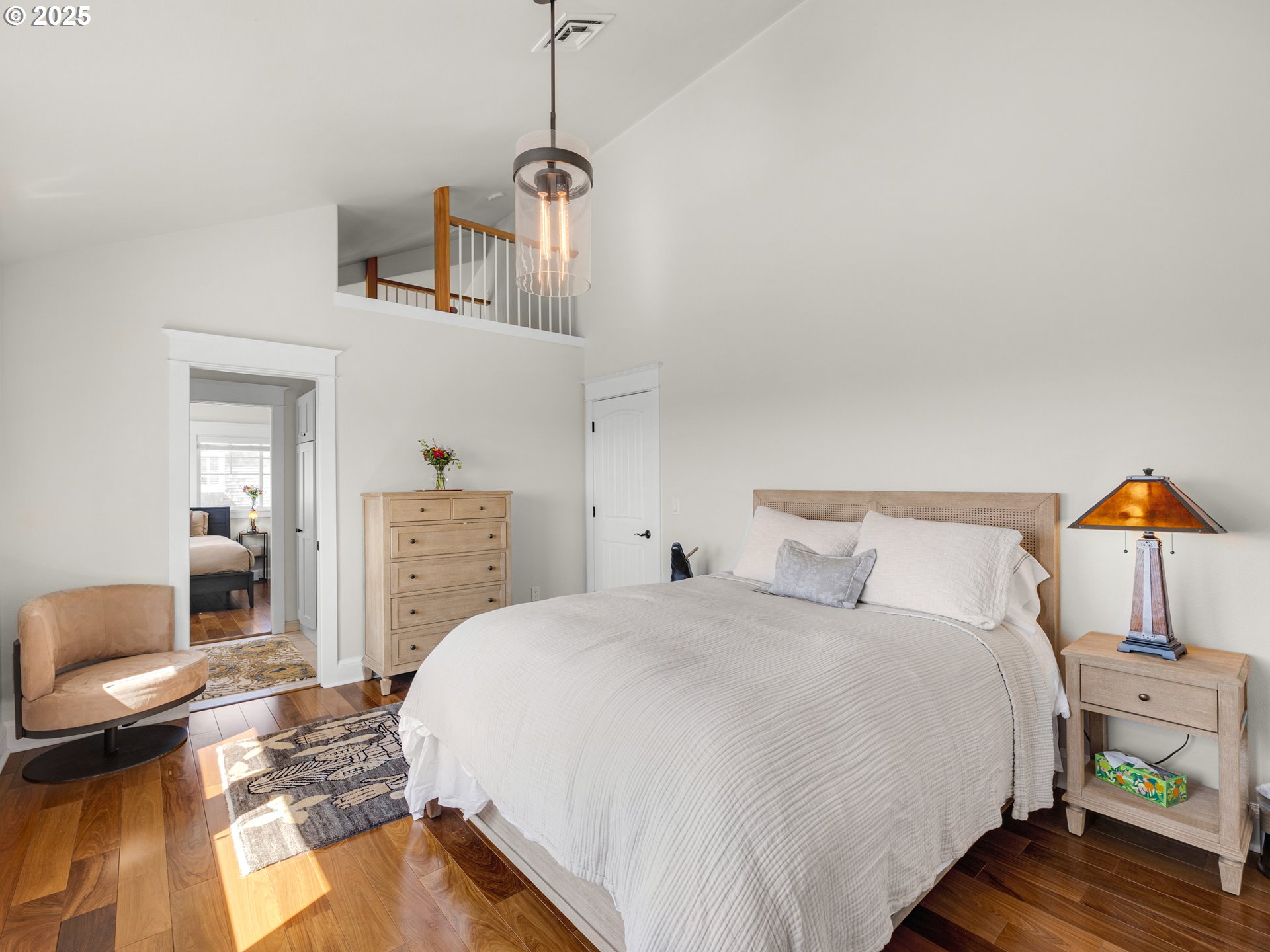 89062 Pinehurst Road Gearhart, OR 97138 - Photo 28 of 42 a bedroom with a bed and wooden floor