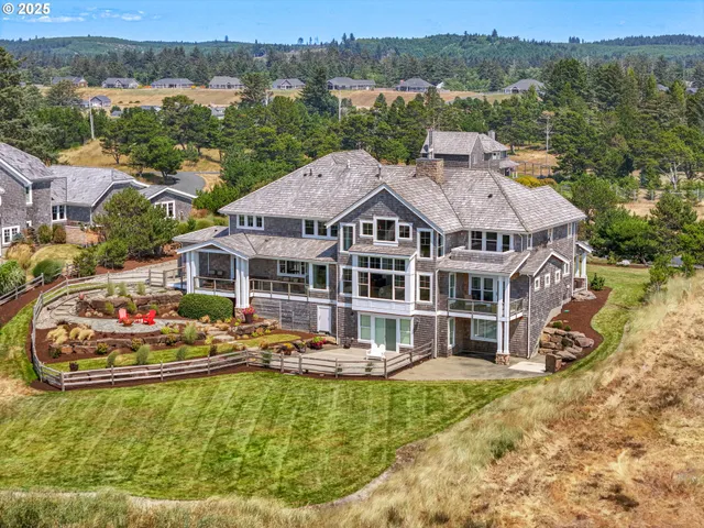 an aerial view of a house with a garden and lake view