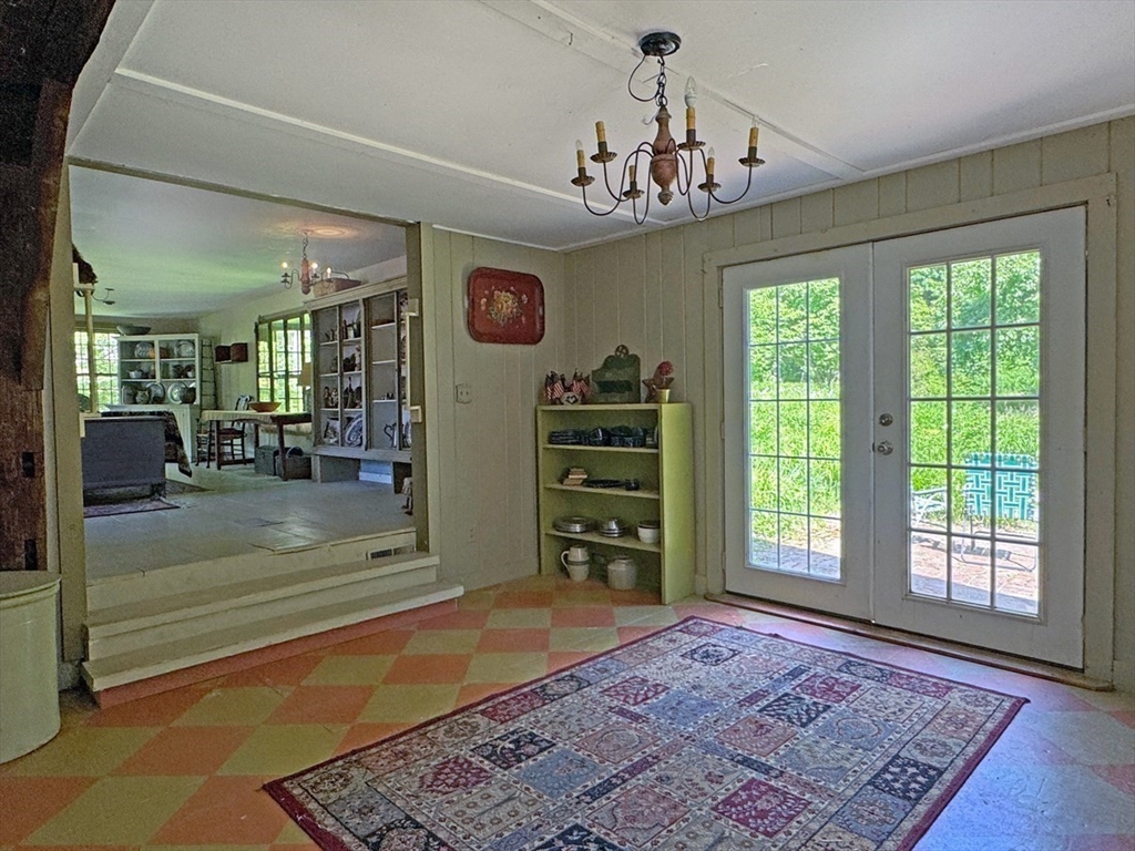 89 Wanamaker Road Northfield, MA 01360 - Photo 25 of 42 a view of a bedroom with a large bed and a chandelier