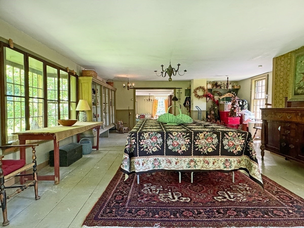 89 Wanamaker Road Northfield, MA 01360 - Photo 28 of 42 a living room with furniture a rug and a table