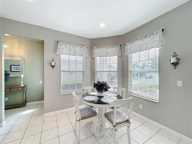 a kitchen with a stove a sink and chairs