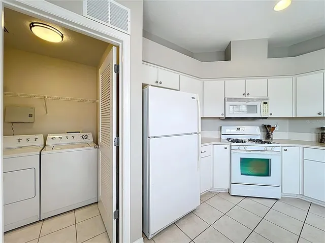 a kitchen with cabinets appliances and a sink