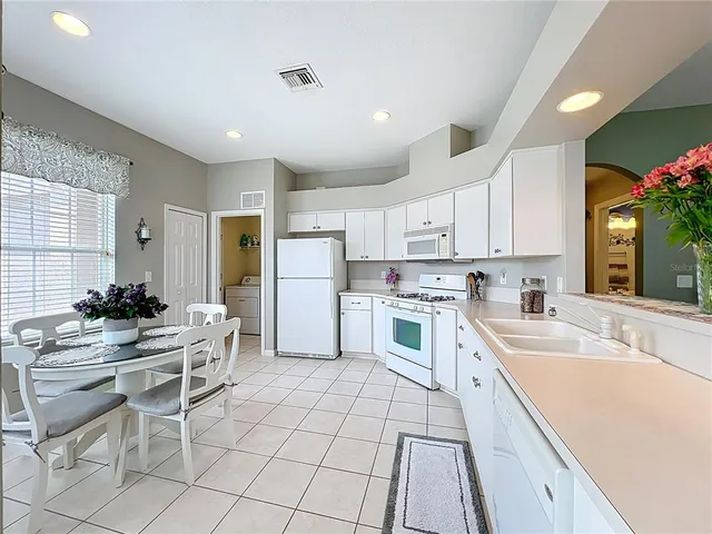 a dining room with chandelier and window