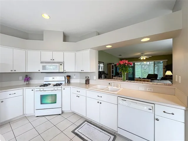 a white refrigerator freezer and a stove sitting inside of a kitchen