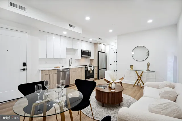 a living room with furniture kitchen and a window