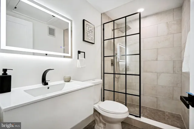 a bathroom with a sink toilet and shower