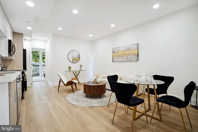 a dining room with furniture and wooden floor