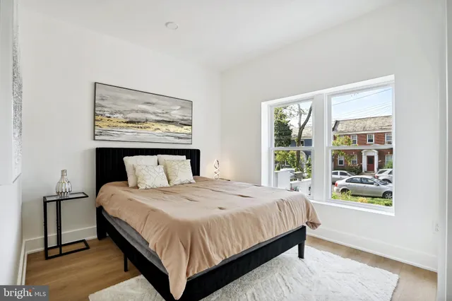 a bedroom with a large bed and a window