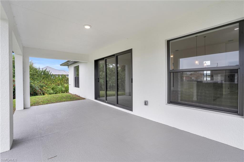 2719 29th Street Southwest Lehigh Acres, FL 33976 - Photo 19 of 23 a view of a house with porch and garden