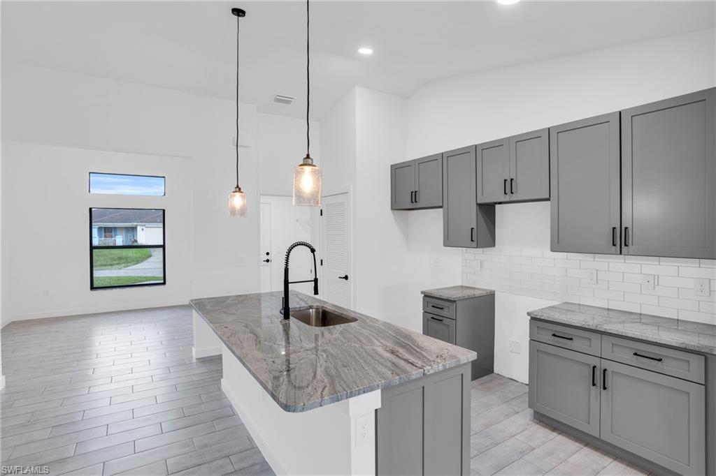 2719 29th Street Southwest Lehigh Acres, FL 33976 - Photo 3 of 23 a kitchen with cabinets a sink and appliances