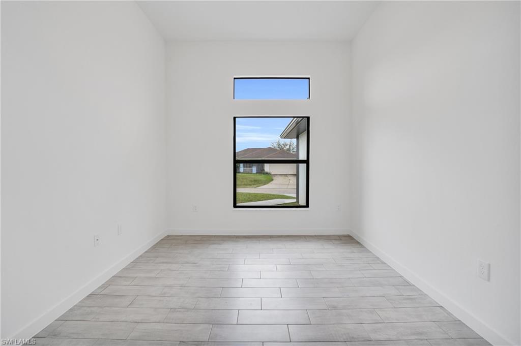 2719 29th Street Southwest Lehigh Acres, FL 33976 - Photo 4 of 23 an empty room with a window