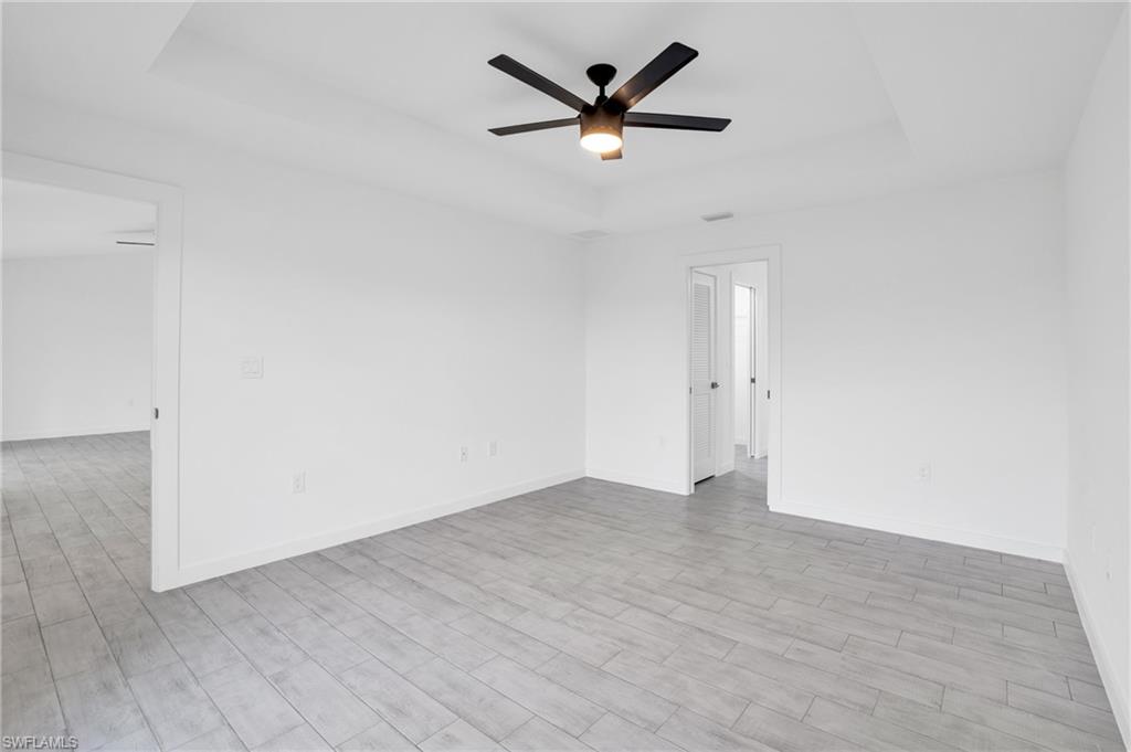 2719 29th Street Southwest Lehigh Acres, FL 33976 - Photo 7 of 23 an empty room with a ceiling fan and window
