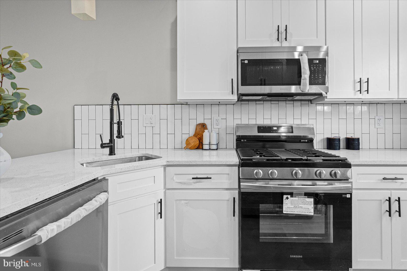 13 South Hilton Street Baltimore, MD 21229 - Photo 11 of 48 a kitchen with cabinets stainless steel appliances and wooden cabinets
