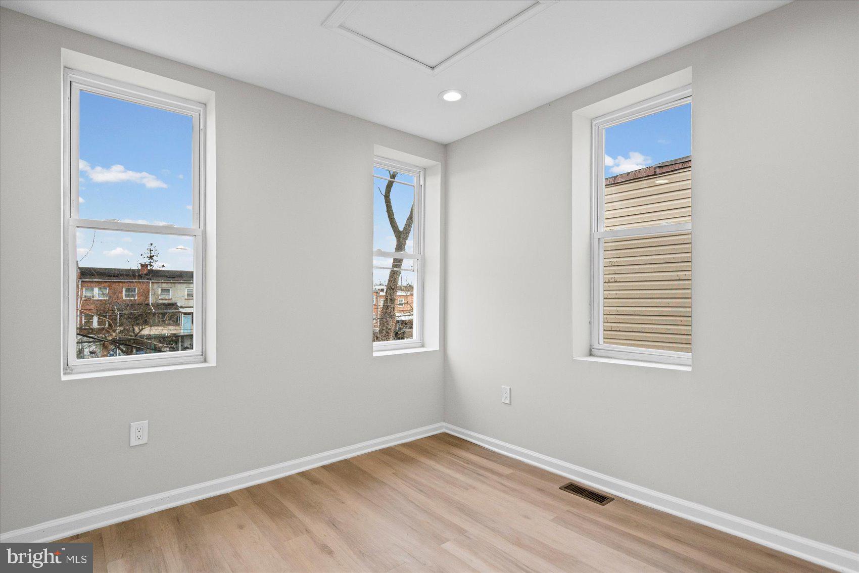 13 South Hilton Street Baltimore, MD 21229 - Photo 24 of 48 a view of an empty room with wooden floor and a window