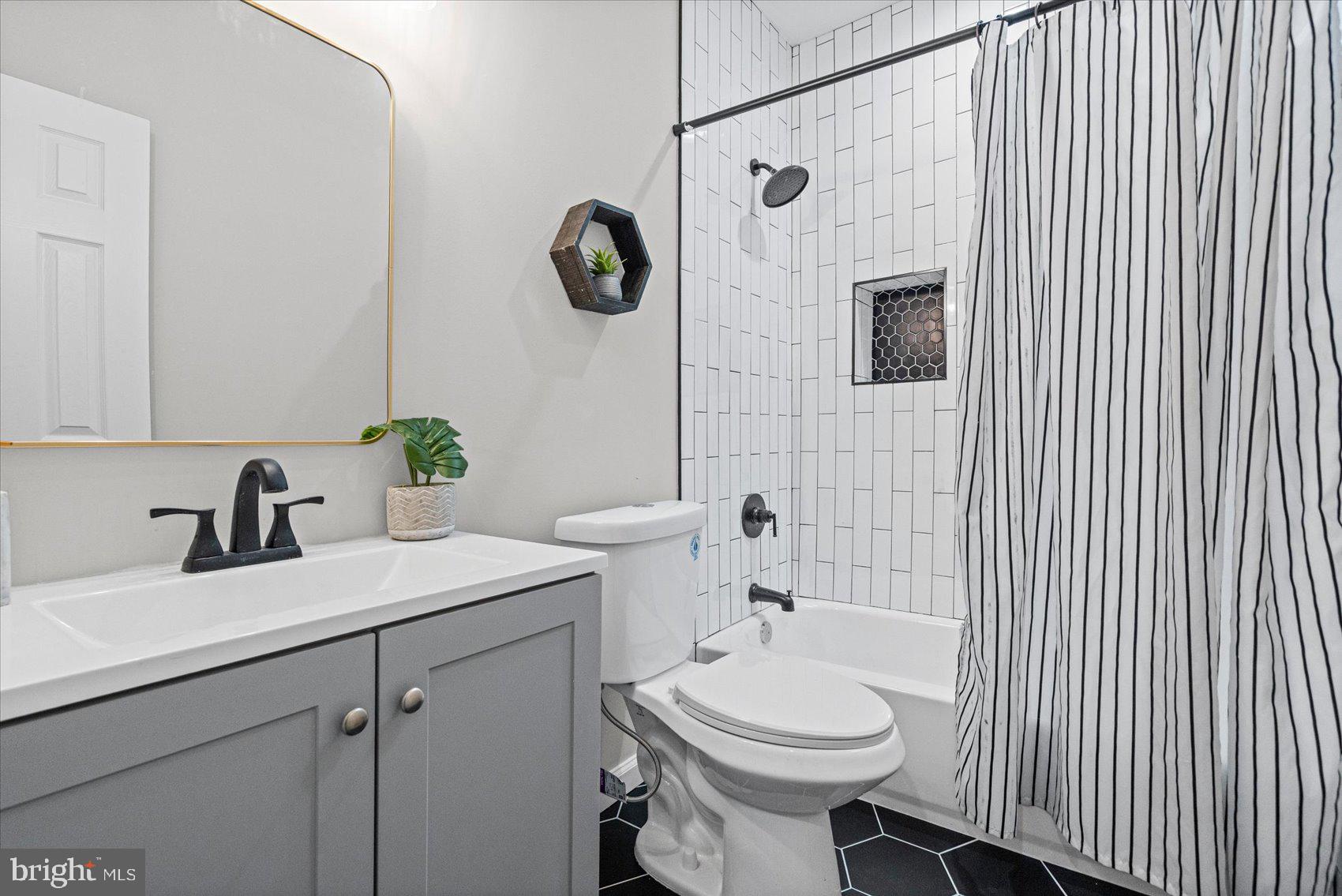 13 South Hilton Street Baltimore, MD 21229 - Photo 28 of 48 a bathroom with a sink a toilet and shower