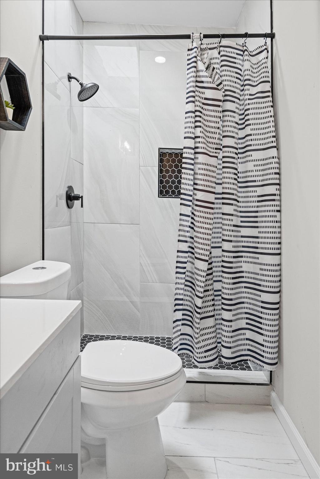 13 South Hilton Street Baltimore, MD 21229 - Photo 32 of 48 a bathroom with a sink a toilet and shower