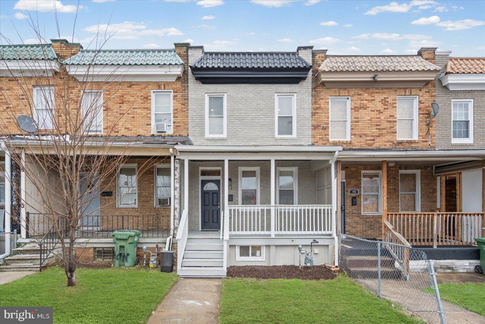 13 South Hilton Street Baltimore, MD 21229 - Photo 44 of 48 a view of a house with a large window and a yard