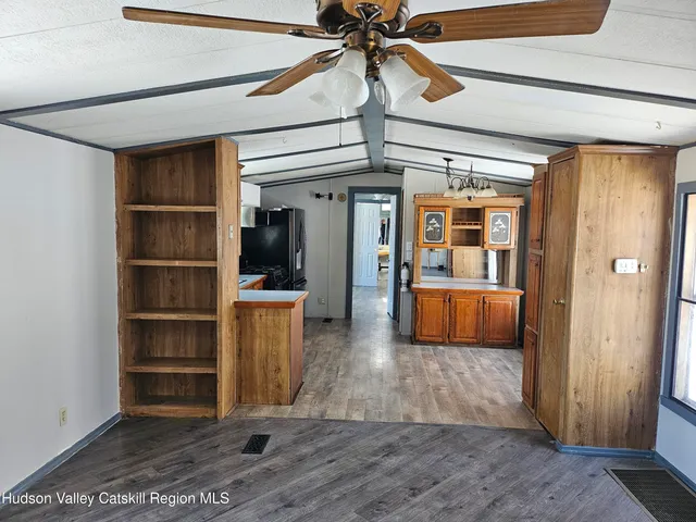 a kitchen with a refrigerator sink and cabinets