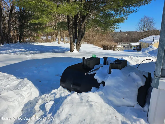 a backyard of a house with table and chairs