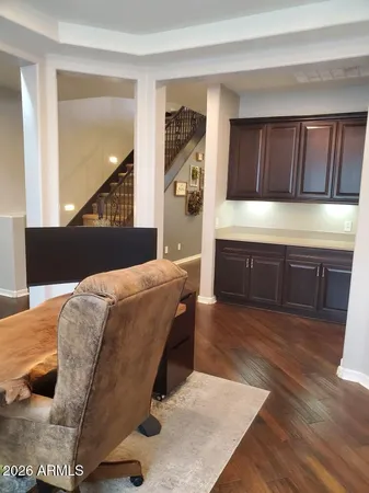 a bed sitting in a spacious bedroom next to a window