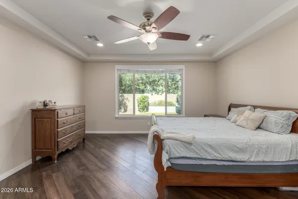 a spacious bedroom with a bed and a chandelier