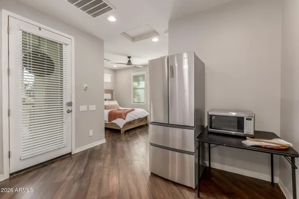 an empty room with windows and ceiling fan