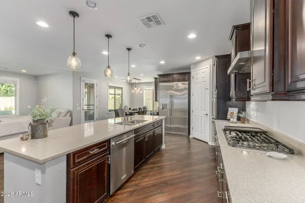 a open kitchen with stainless steel appliances granite countertop a sink stove and refrigerator