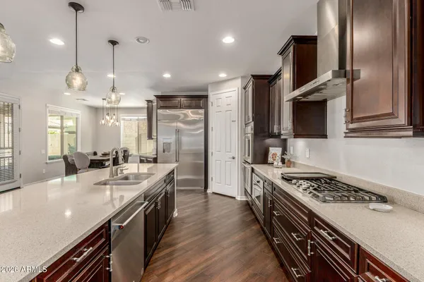 a kitchen with stainless steel appliances a sink stove and refrigerator